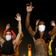 Demonstrators raise their arms and chant, “Hands up, Don’t Shoot”, as police clear them from the street as they protest the shooting death of Michael Brown on August 17, 2014 in Ferguson, Missouri.